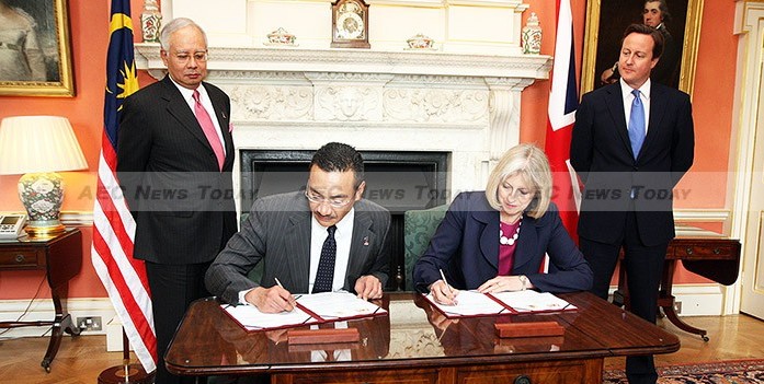 File photo: British Prime Minister David Cameron and Prime Minister Najib Razak look on as Memorandum of Understanding on transnational crime is signed on 14 July 2011