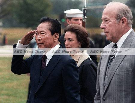 File Photo: Former Philippines dictator Ferdinand Marcos, Sr., with then US Secretary of State, George Shultz: The Philippines will be saddled with Marcos's debt until 2025