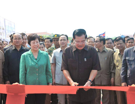 Cambodian Prime Minister Hun Sen (Front) cuts the ribbon to inaugurate a China-funded 1.73km (1.3 mile) bridge across the Mekong River and a 143km (85.86 mile) section of road in Stung Treng province, Cambodia, April 1, 2015.