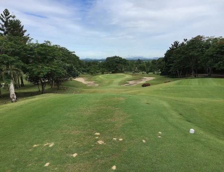 Spectacular scenery at the Royal Ratchaburi golf course. Here the dramatic drop to the green on the 11th hole with the mountains of Myanmar line the horizon.