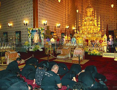 Thais mourning the death of King Bhumibol Adulyadej prostrate before the Royal Urn