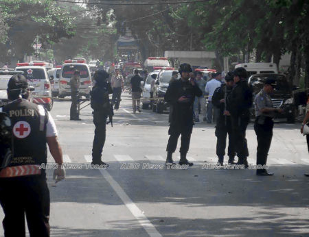 Police officers stand guard in the wake of Surabaya church bombing in May 2018